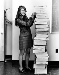 Margaret Hamilton with the printed AGC source code.